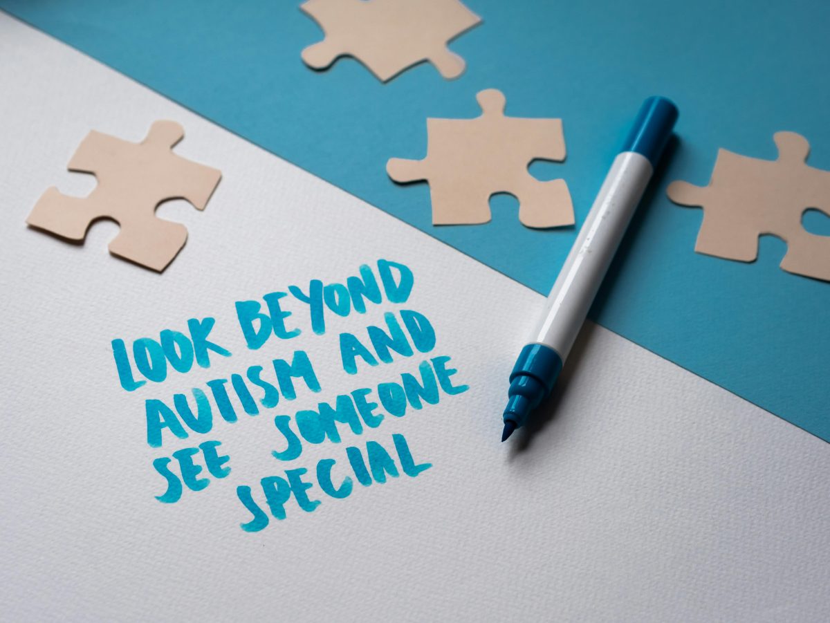 Inspirational autism awareness message with puzzle pieces and handwritten text.